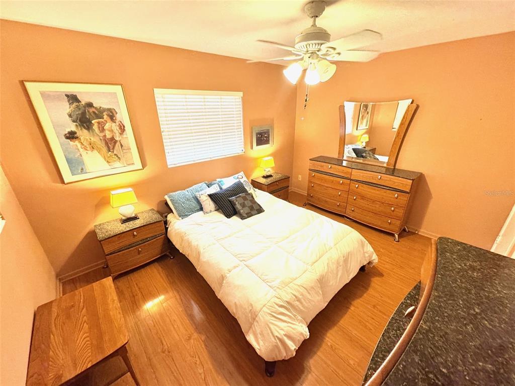 1035 Robmar Road Dunedin, FL 34698 - Photo 17 of 40 a bedroom with a bed a couch and a window