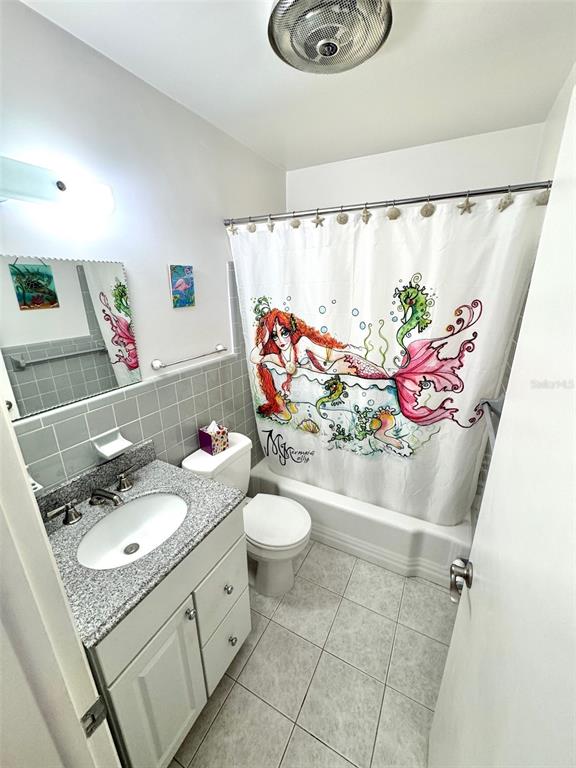 1035 Robmar Road Dunedin, FL 34698 - Photo 18 of 40 a bathroom with a sink a vanity and a mirror