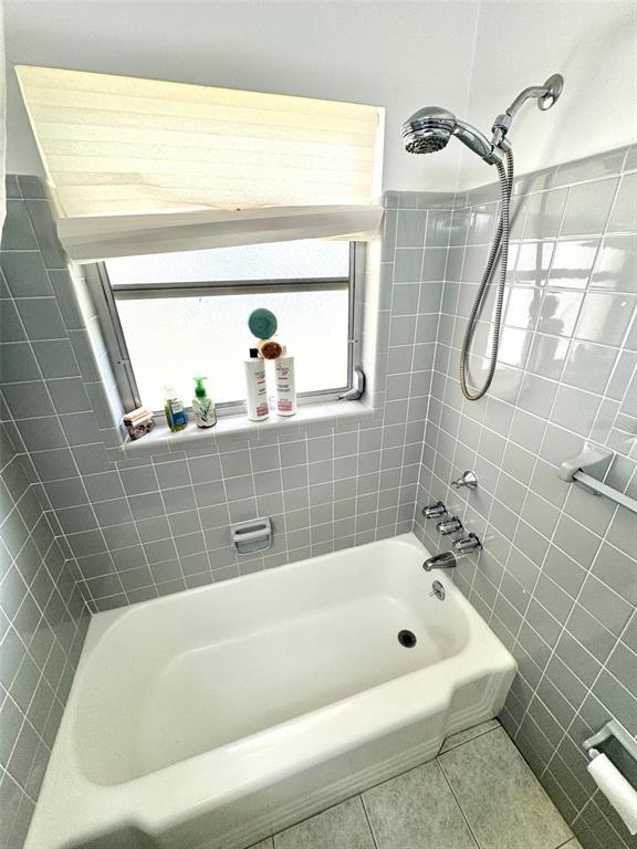 1035 Robmar Road Dunedin, FL 34698 - Photo 20 of 40 a bathroom with a tub a shower and vanity