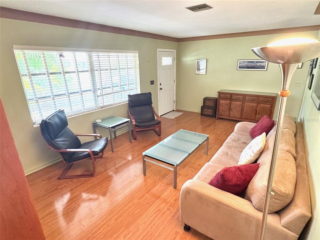 1035 Robmar Road Dunedin, FL 34698 - Photo 5 of 40 a living room with furniture and a window