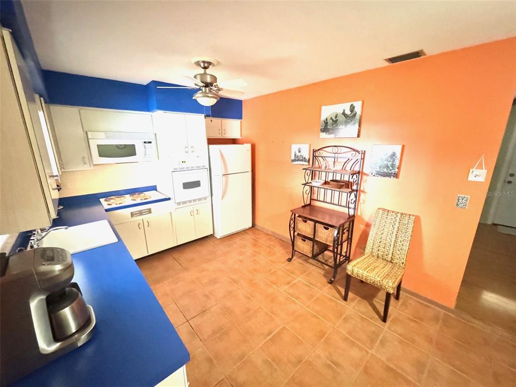 1035 Robmar Road Dunedin, FL 34698 - Photo 8 of 40 a living room with furniture and a wooden floor