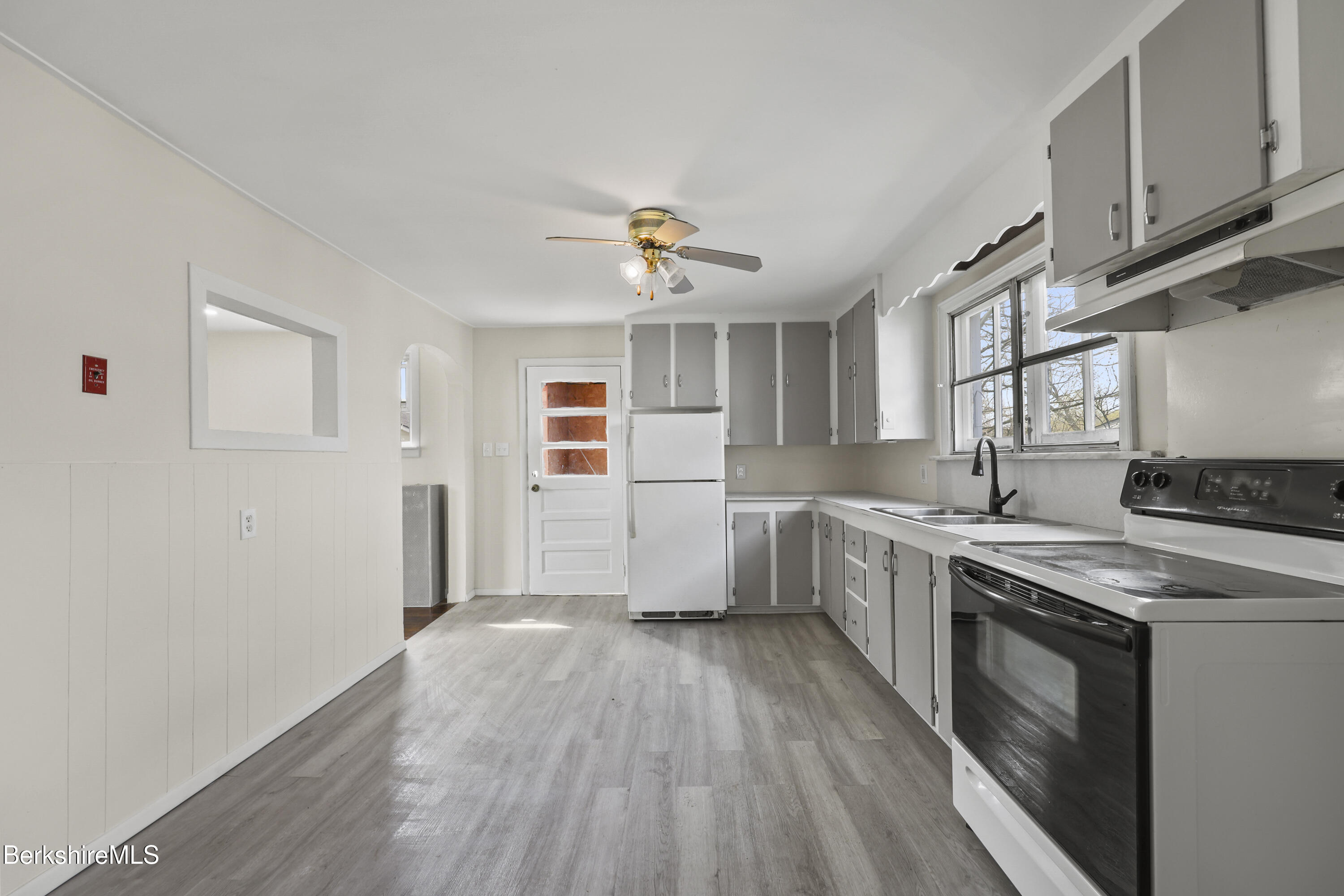 49 McArthur Street Pittsfield, MA 01201 - Photo 11 of 33 a kitchen with cabinets wooden floor and stainless steel appliances
