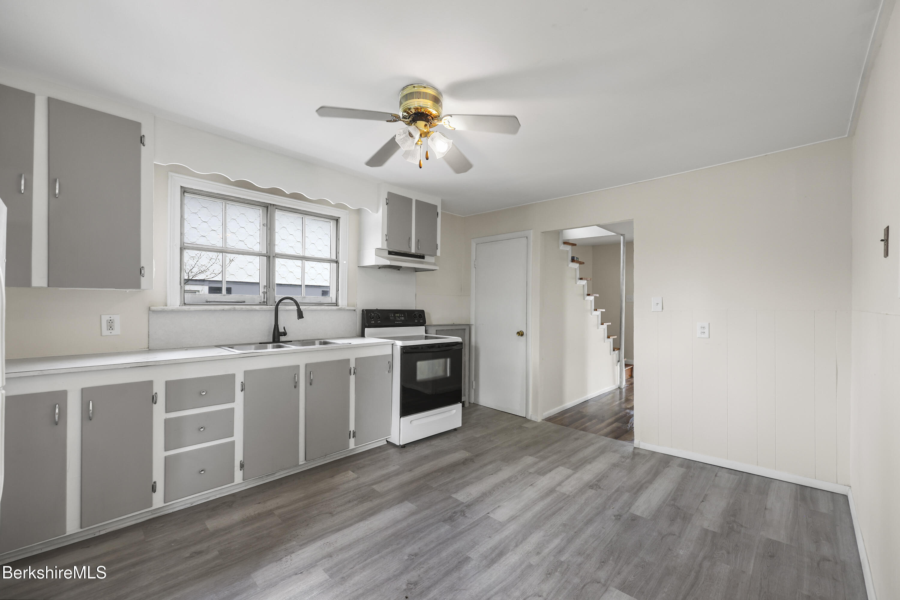 49 McArthur Street Pittsfield, MA 01201 - Photo 13 of 33 a kitchen with a white cabinets and chandelier