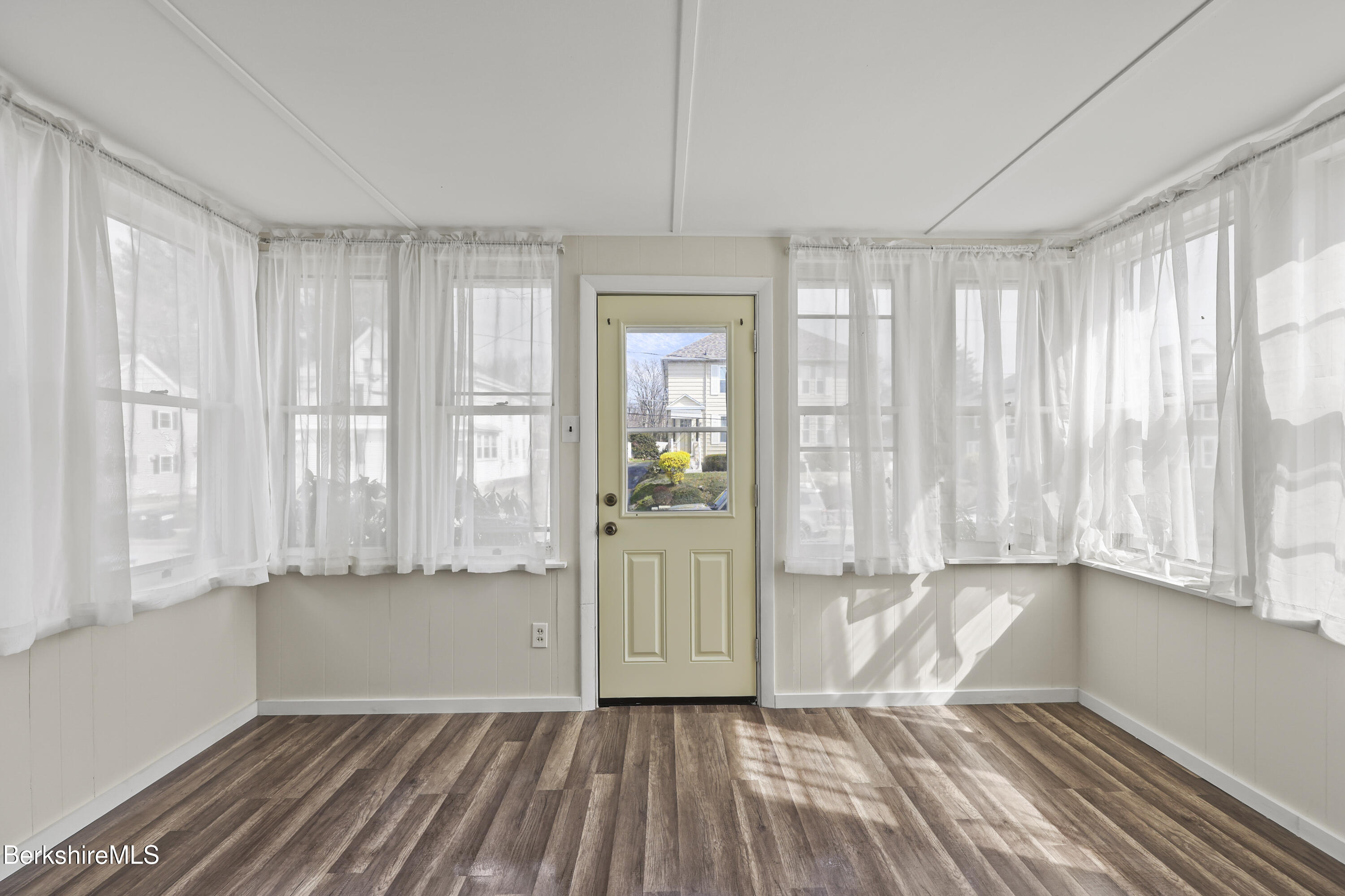 49 McArthur Street Pittsfield, MA 01201 - Photo 3 of 33 a view of an empty room with wooden floor and a window