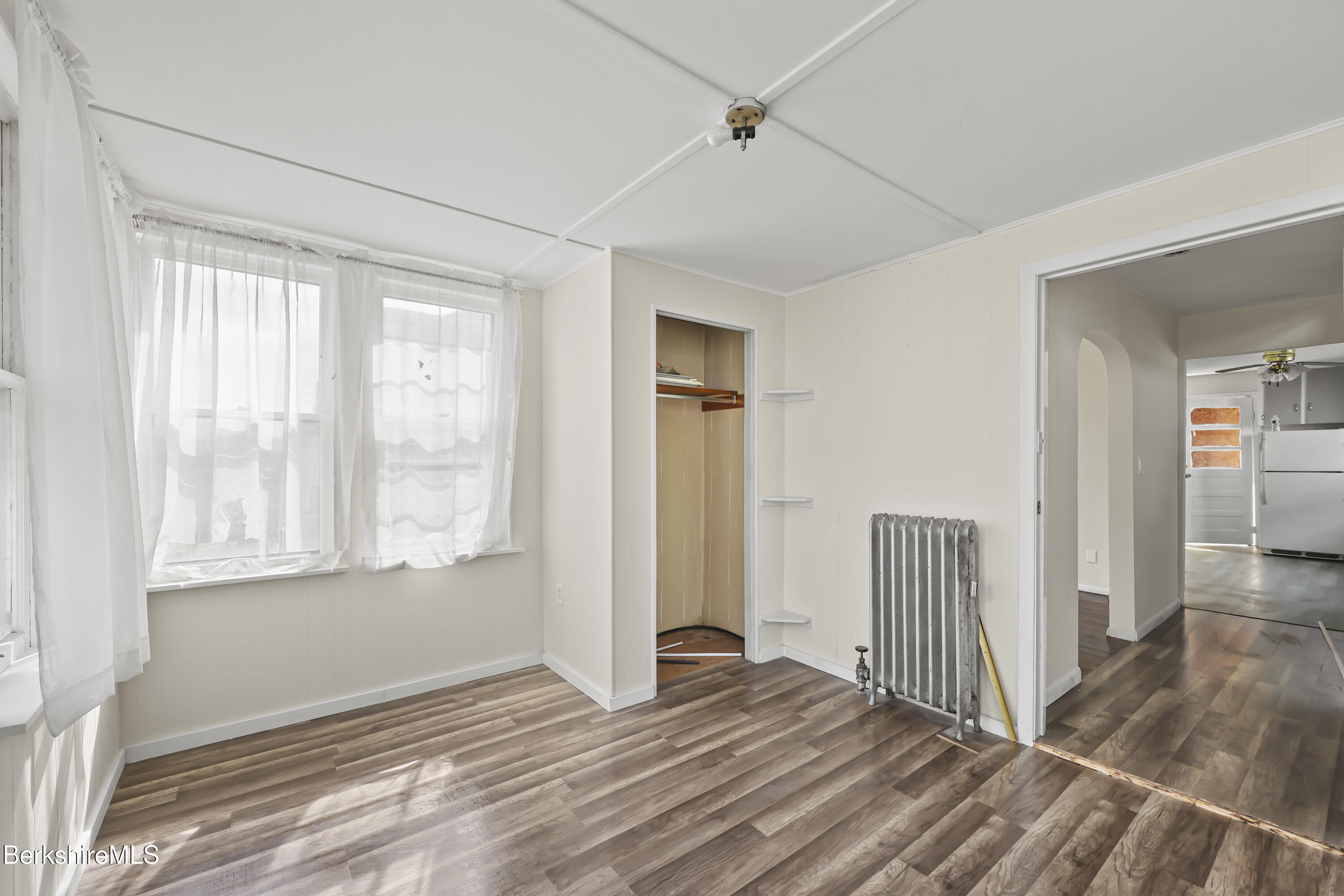 49 McArthur Street Pittsfield, MA 01201 - Photo 4 of 33 a view of an empty room with wooden floor and a window