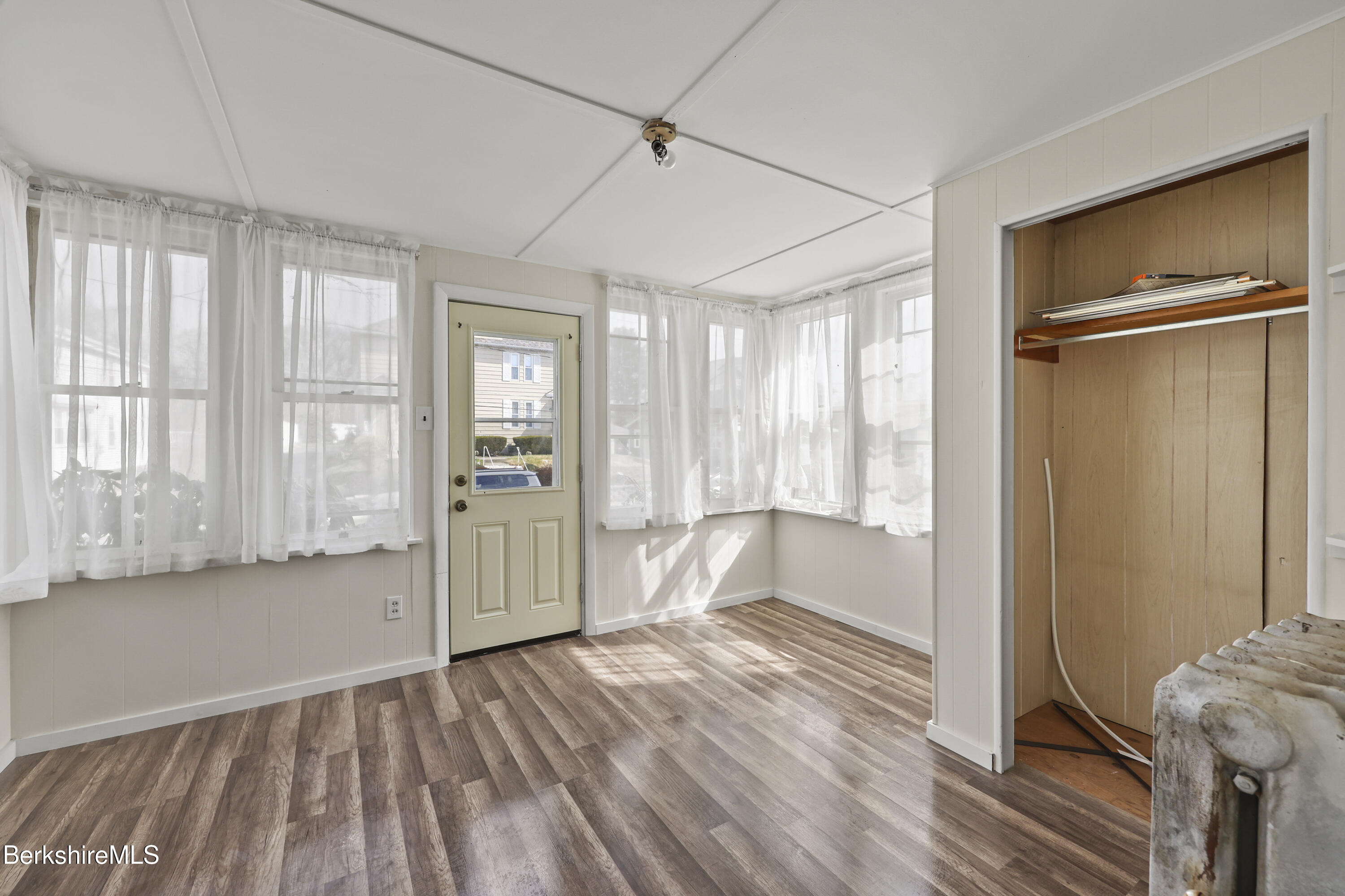 49 McArthur Street Pittsfield, MA 01201 - Photo 5 of 33 a view of an empty room with a window and wooden floor