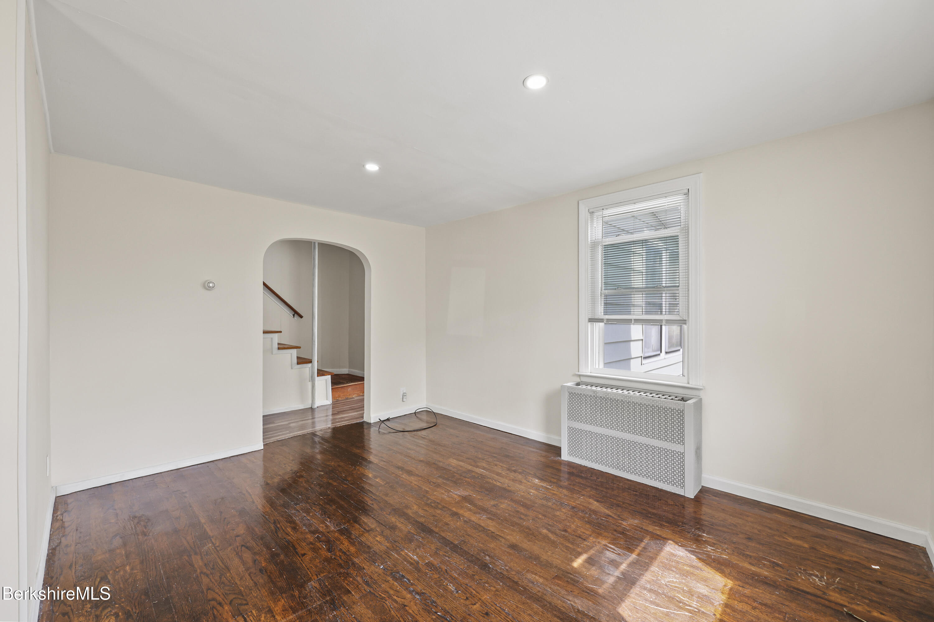 49 McArthur Street Pittsfield, MA 01201 - Photo 8 of 33 an empty room with wooden floor and windows