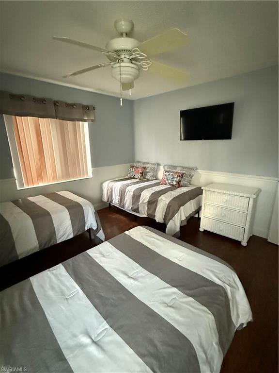 760 Augusta Boulevard, Unit D204 Naples, FL 34113 - Photo 31 of 32 a bedroom with two beds and a flat screen tv