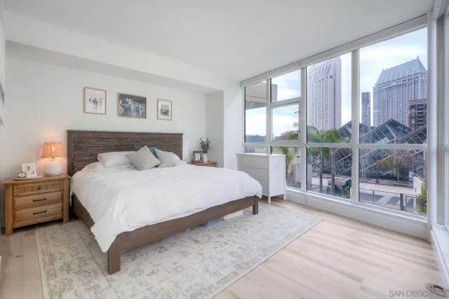 a bedroom with a large bed and a night stand