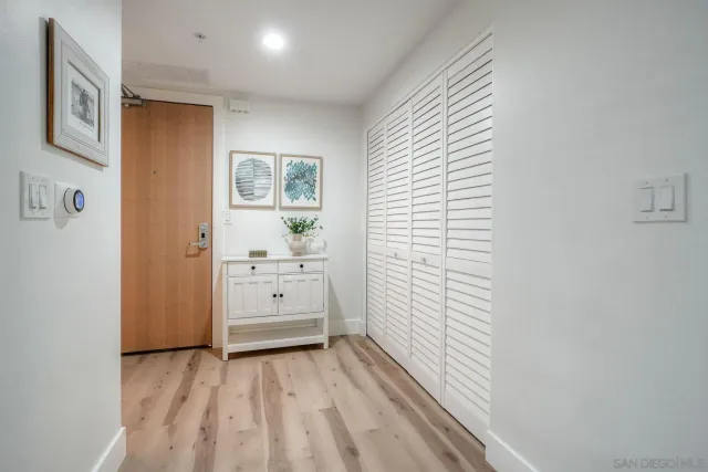 a view of a hallway with closet and bathroom