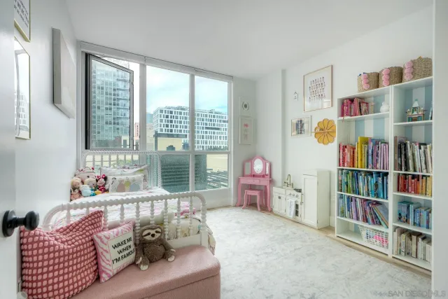 a living room with furniture and a book shelf
