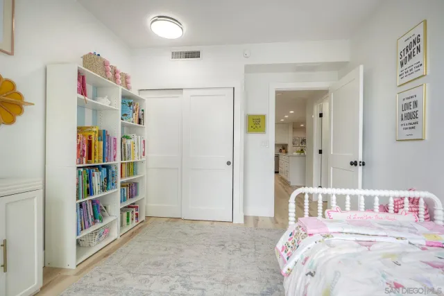 a bedroom with a bed and a book shelf