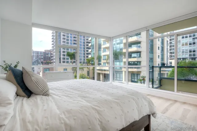 a bedroom with a large bed and a large window