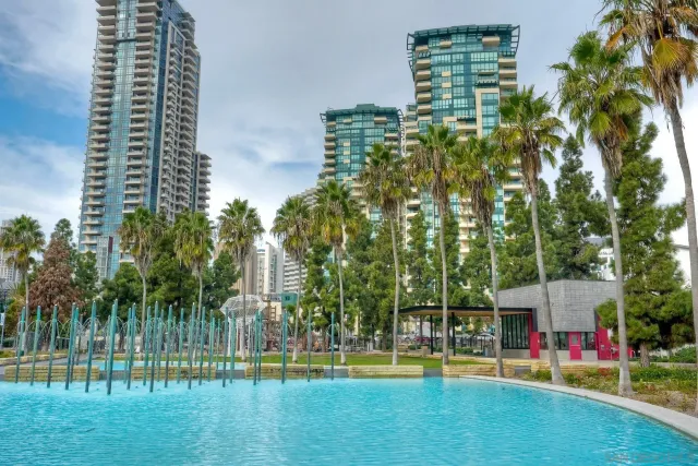 a view of a city with tall buildings and a big yard