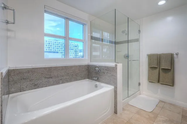 a spacious bathroom with a bathtub and a shower