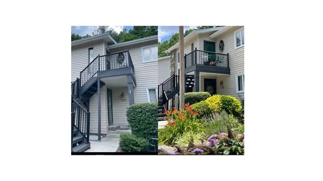 a black and white house with a large window and potted plants