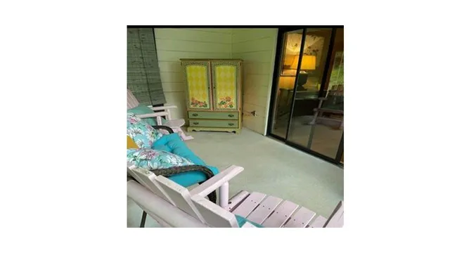 a living room with a couch and a table with mirror