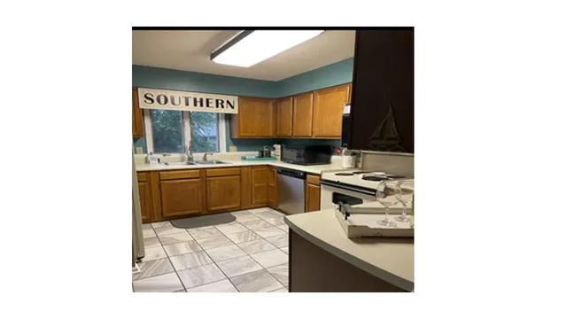 a kitchen with a sink cabinets and appliances
