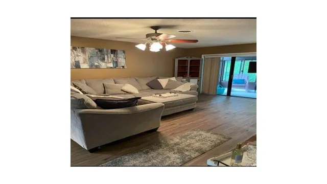 a living room with furniture and a chandelier
