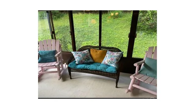 a living room with a couch a table and a potted plant