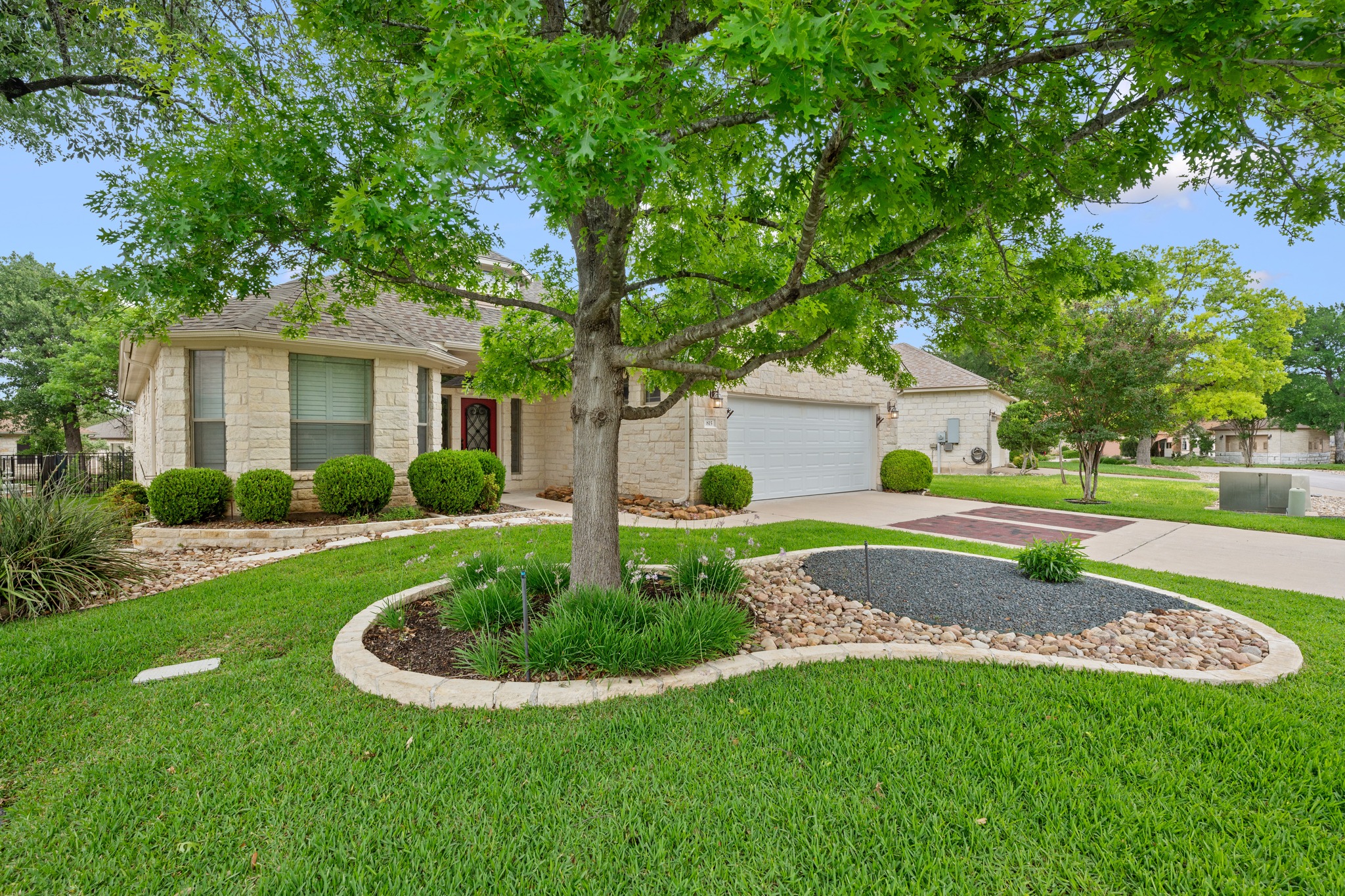 The intricate landscaping and two-car garage, complete with a new door installed in December 2025, make this Heritage Oaks home a standout on the block