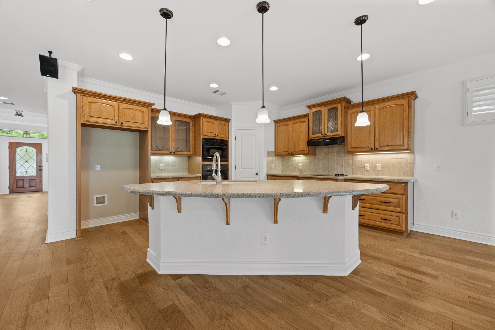 815 River Walk Trail Georgetown, TX 78633 - Photo 12 of 36 The center island provides extra prep space, while the tile backsplash adds a classic touch to the cooking area