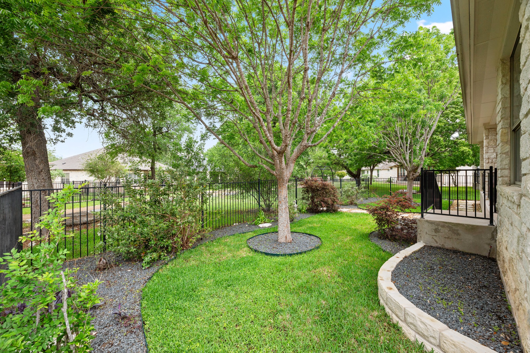 815 River Walk Trail Georgetown, TX 78633 - Photo 29 of 36 The beautiful lawn is framed by mature trees and intricate, lush landscaping, offering a rich and sprawling green space!