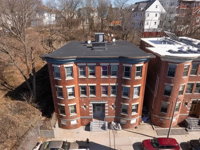 a front view of a building with a yard