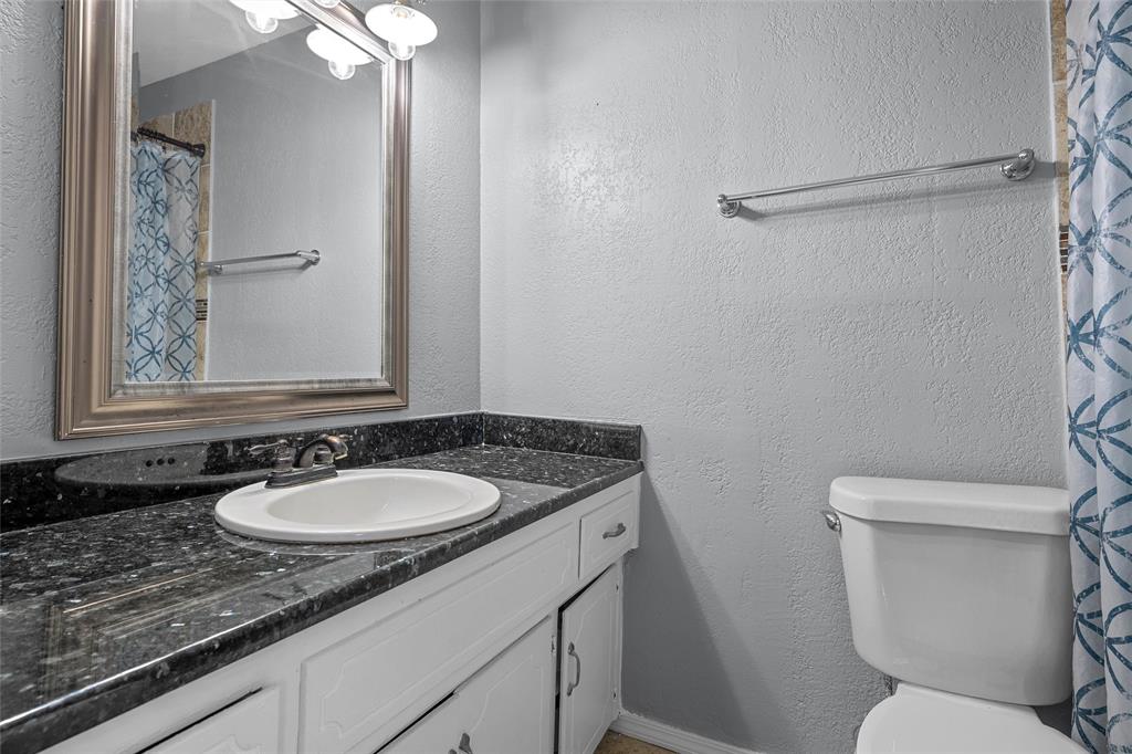 711 Rosedale Drive Hewitt, TX 76643 - Photo 13 of 16 a bathroom with a granite countertop sink toilet and a mirror