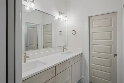 a white toilet and tub sitting next to a white cabinet