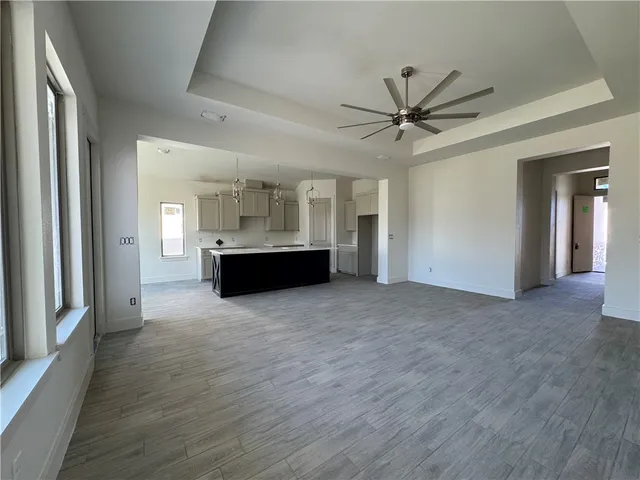 a view of a kitchen with a sink and a refrigerator