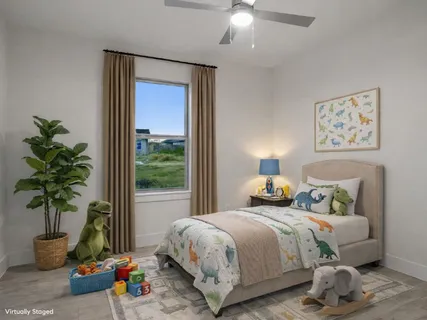 a bedroom with bed and a potted plant