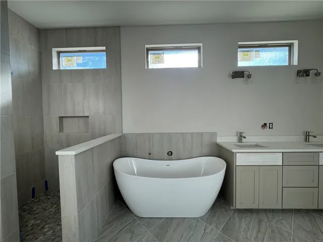 a bathroom with a bathtub and sink