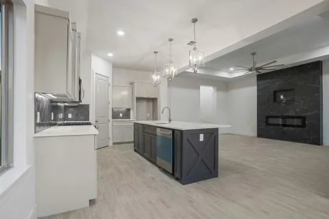 a large kitchen with kitchen island a sink stainless steel appliances and cabinets