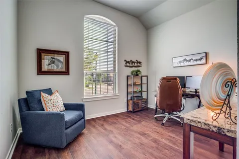 a living room with furniture a wooden floor and a window