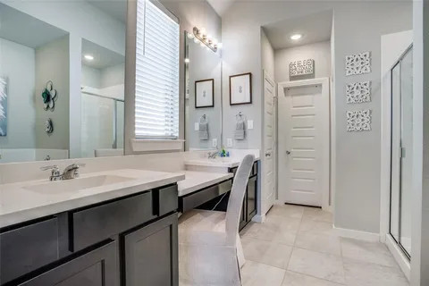 a spacious bathroom with a sink a toilet a mirror and shower