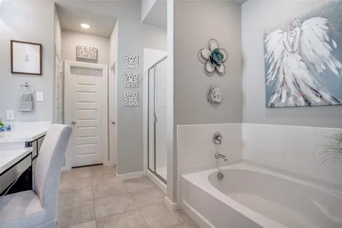 a bathroom with a tub sink and shower