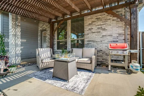 a backyard of a house with table and chairs