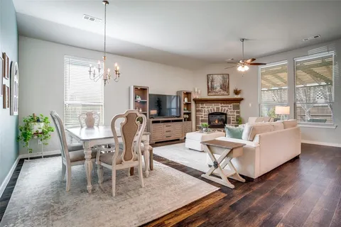 a living room with fireplace furniture and a chandelier