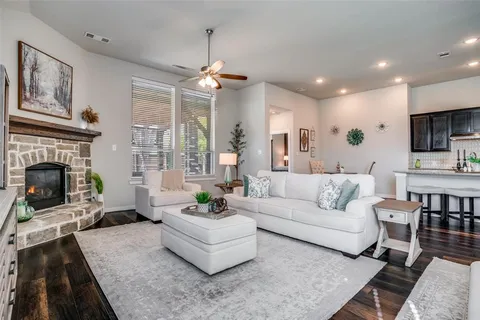 a living room with furniture a fireplace and a flat screen tv