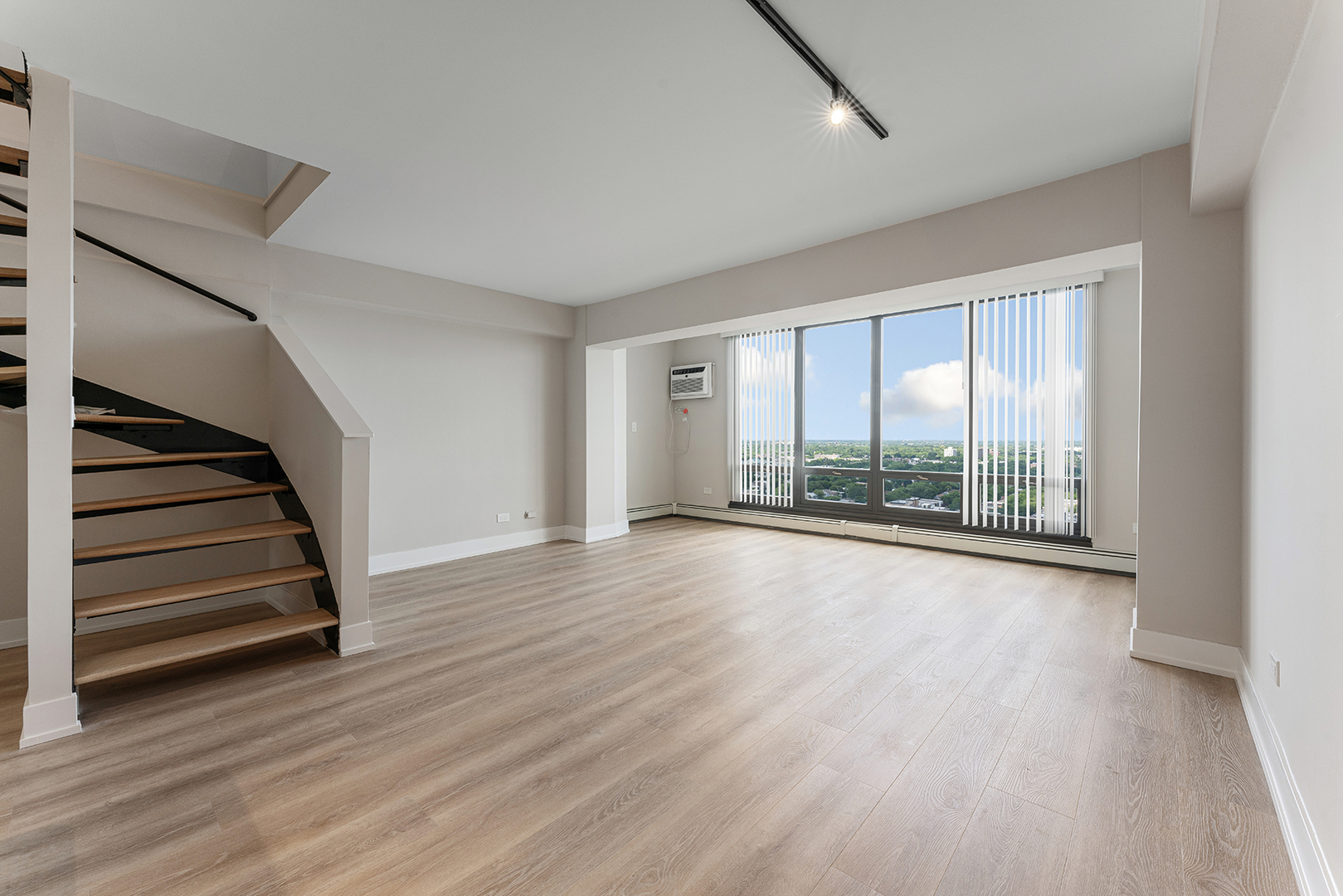 6166 North Sheridan Road, Unit 16A Chicago, IL 60660 - Photo 2 of 17 wooden floor in an empty room with a window