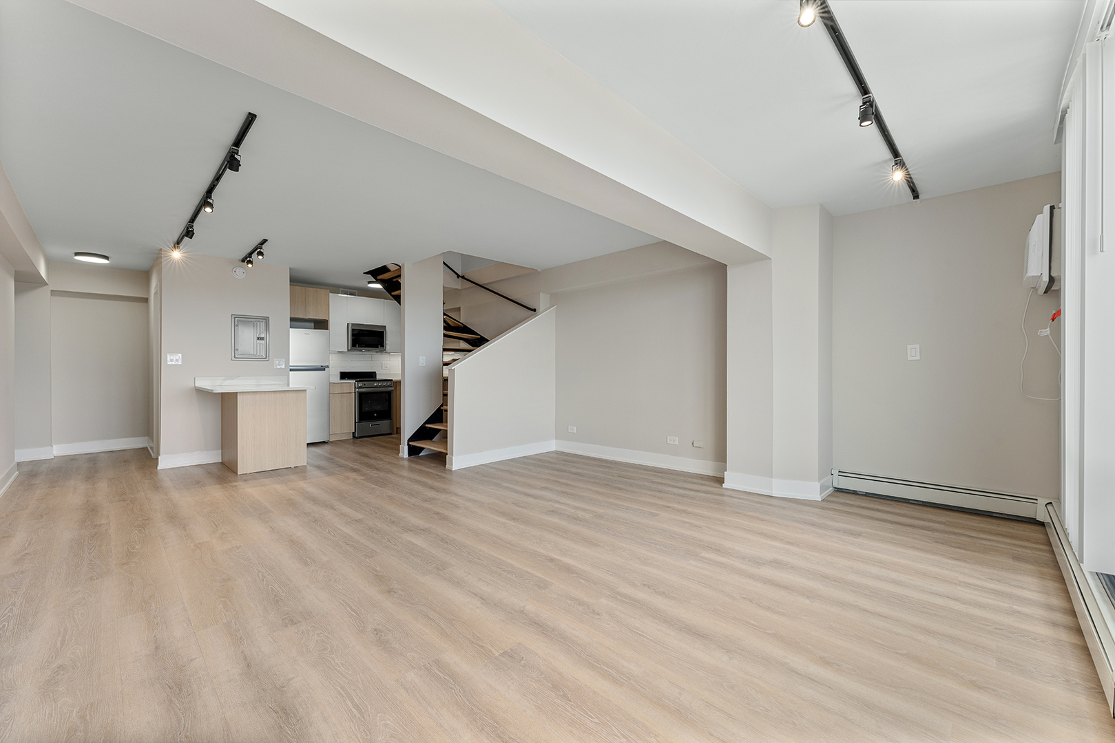 6166 North Sheridan Road, Unit 16A Chicago, IL 60660 - Photo 3 of 17 a view of a kitchen with a sink and a refrigerator