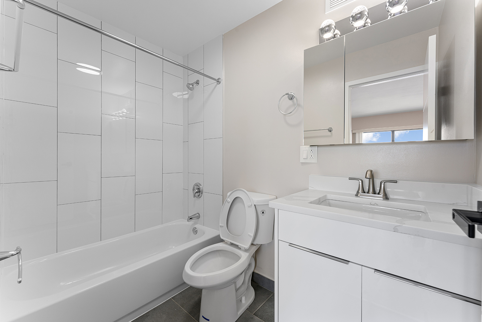 6166 North Sheridan Road, Unit 16A Chicago, IL 60660 - Photo 10 of 17 a bathroom with a sink toilet a mirror and shower