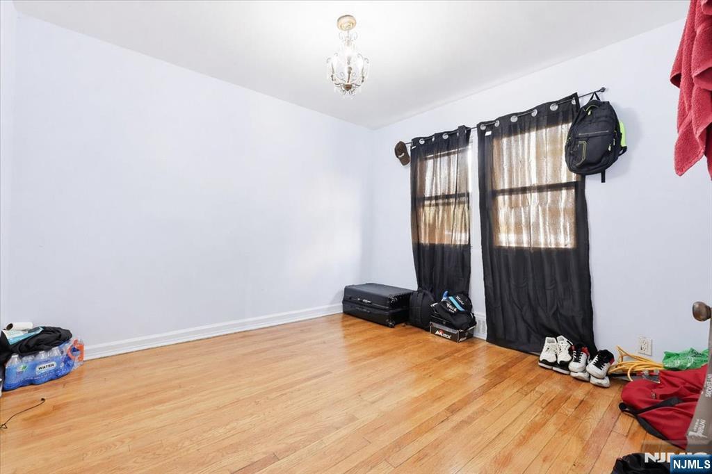 409 Tryon Avenue Englewood, NJ 07631 - Photo 13 of 33 a bedroom with a bed and a window