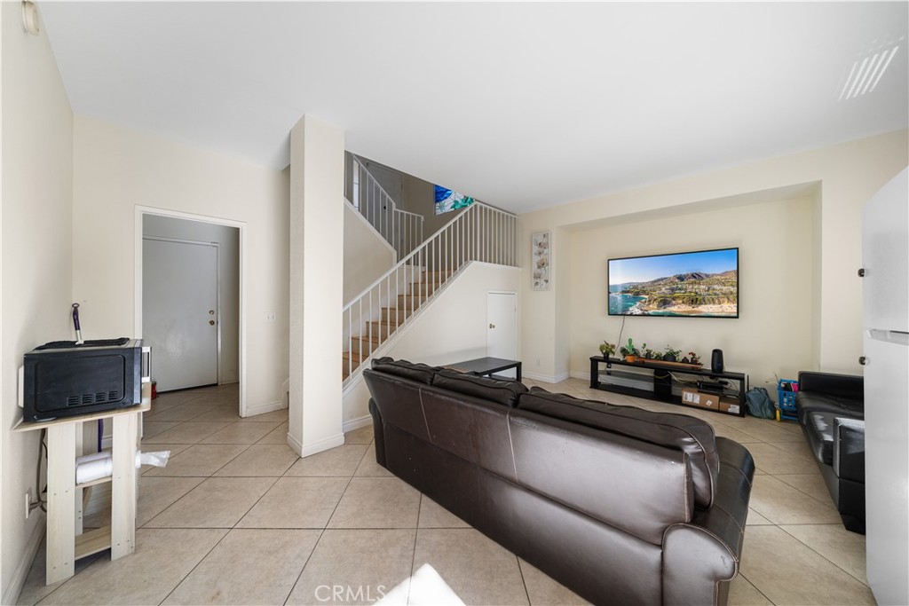 11159 St Tropez Drive Rancho Cucamonga, CA 91730 - Photo 12 of 40 a living room with furniture and a flat screen tv