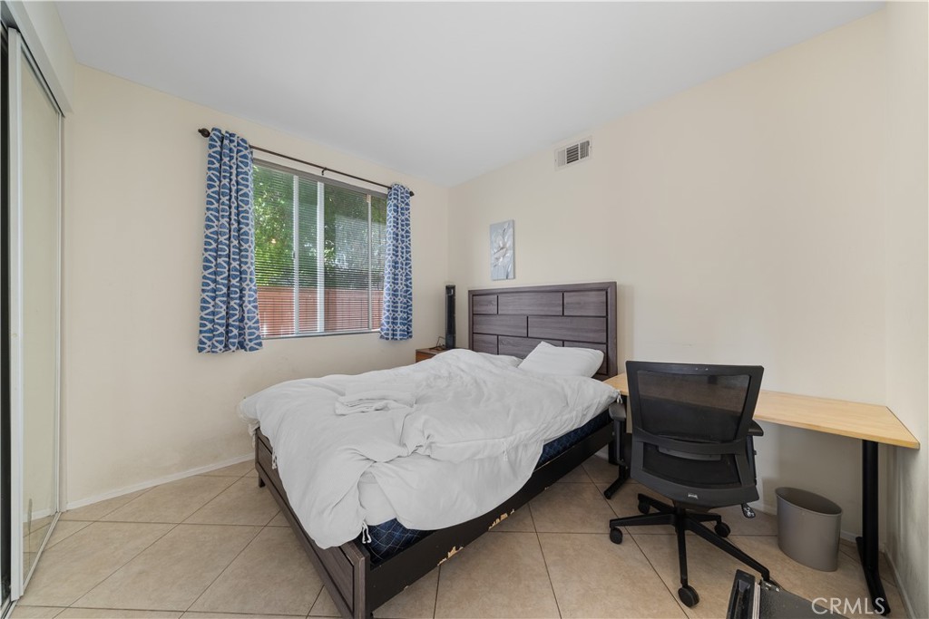 11159 St Tropez Drive Rancho Cucamonga, CA 91730 - Photo 14 of 40 a bedroom with a bed and a window