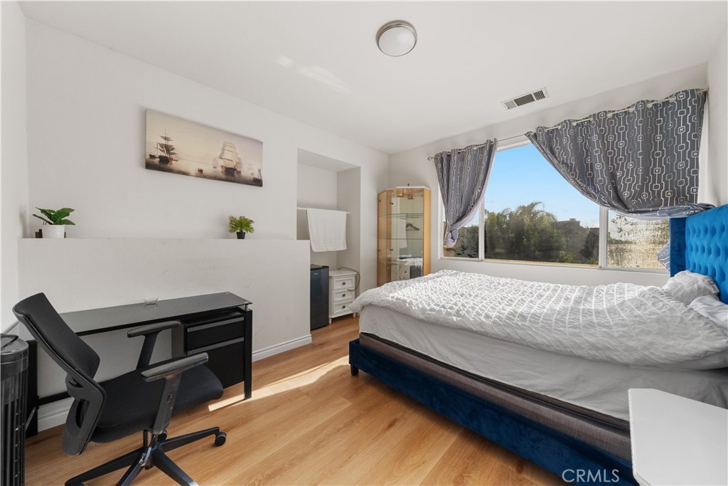 11159 St Tropez Drive Rancho Cucamonga, CA 91730 - Photo 17 of 40 a bedroom with a bed a desk and chair