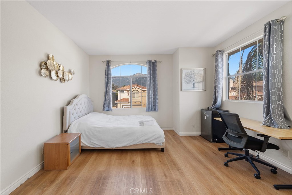 11159 St Tropez Drive Rancho Cucamonga, CA 91730 - Photo 29 of 40 a bedroom with a bed and wooden floor