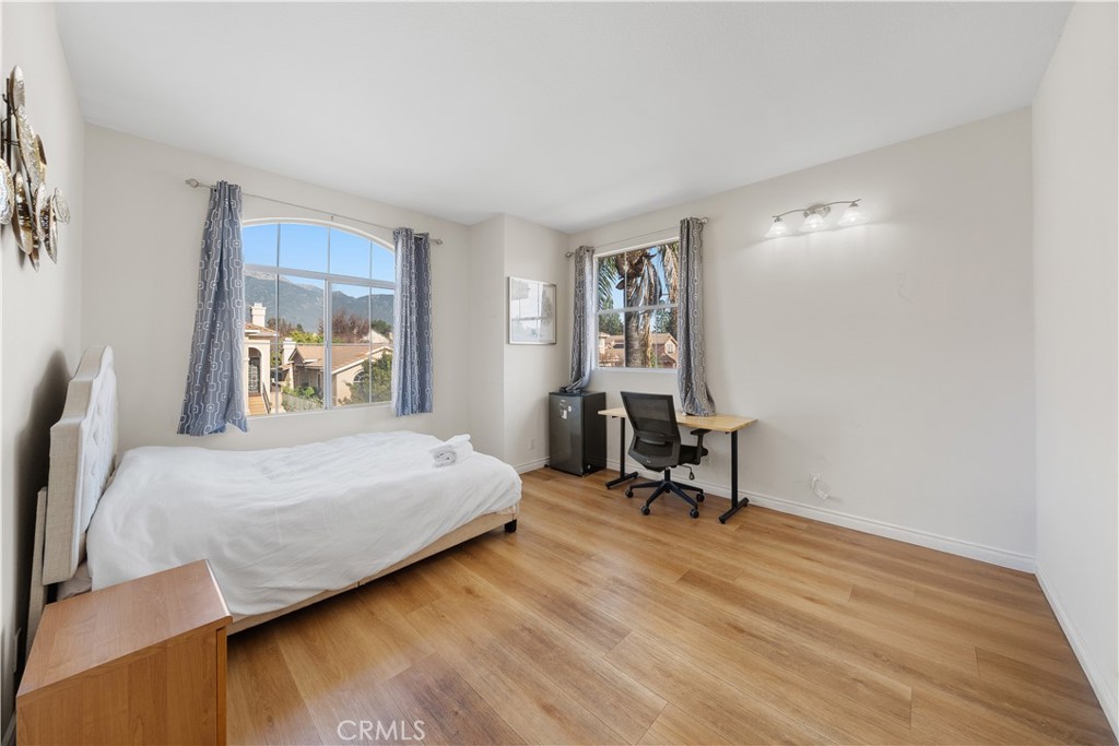 11159 St Tropez Drive Rancho Cucamonga, CA 91730 - Photo 30 of 40 a bedroom with a bed a table and painting on the wall