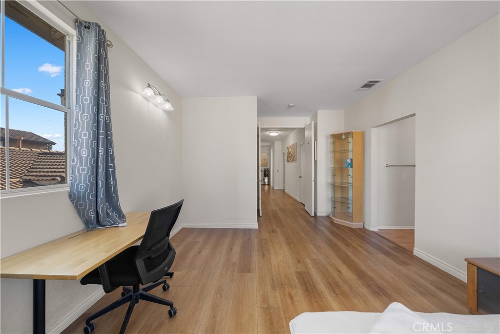 11159 St Tropez Drive Rancho Cucamonga, CA 91730 - Photo 31 of 40 a view of a room with furniture and wooden floor